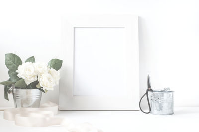 White flower vase on table at home