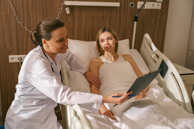 Female doctor examining patient in hospital