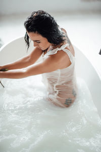 High angel view of woman sitting in bathtub