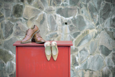 Low section of woman on rock against wall