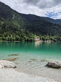 Scenic view of lake by mountains against sky