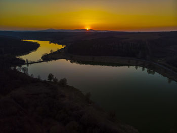 Scenic view of lake against sky during sunset