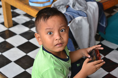 Close-up of boy using mobile phone