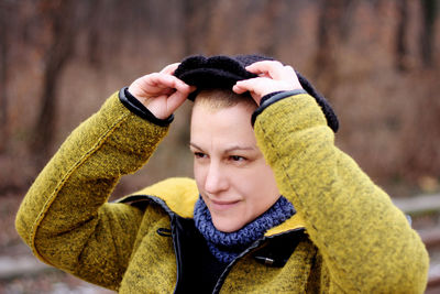 Smiling woman looking away wearing hat during winter