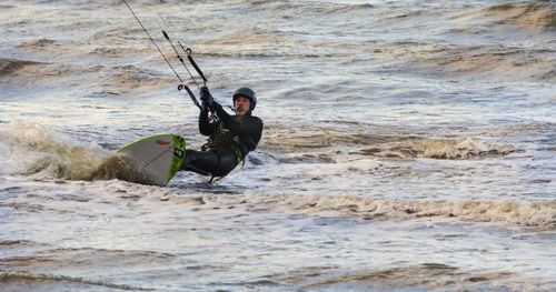 Full length of woman jumping in water