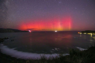 Scenic view of sea against sky at night