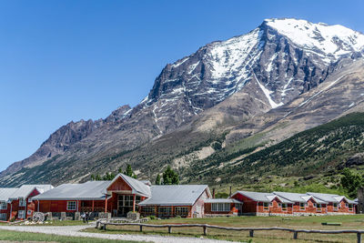 Houses on snowcapped mountain against sky