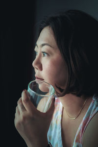 Close-up portrait of young woman drinking coffee