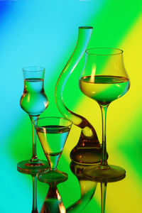 Close-up of wineglass on table against blue background