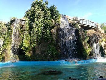 Scenic view of waterfall against sky