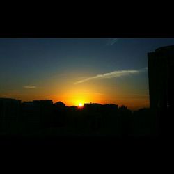 Silhouette of built structures at sunset