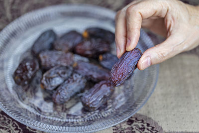 Cropped hand of person holding food