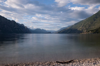 Scenic view of lake by mountains against sky