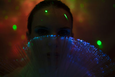 Close-up portrait of girl with illuminated light painting