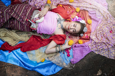 High angle view of mother and daughter lying on bed