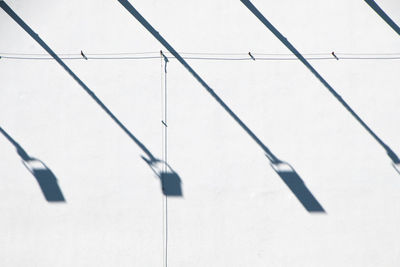 High angle view of metal railing against white wall