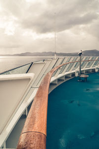 Swimming pool by sea against sky