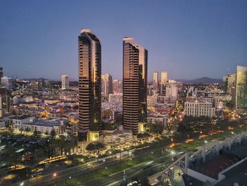 High angle view of illuminated buildings against sky at night