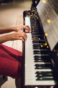 Midsection of person playing piano