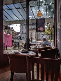 Man sitting in restaurant seen through glass window