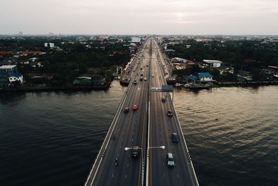 High angle view of bridge over river in city against sky