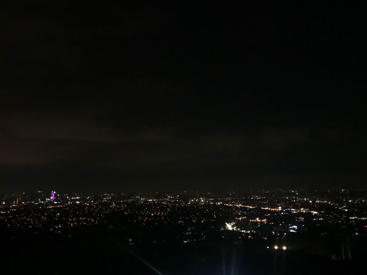 HIGH ANGLE VIEW OF ILLUMINATED BUILDINGS AT NIGHT