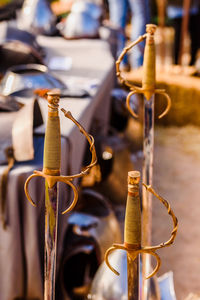 Close-up of metal hanging on pole against blurred background