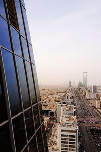 Buildings in city against clear sky