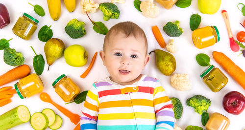 High angle view of cute baby boy holding food