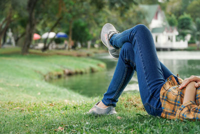 Low section of man wearing shoes on grass