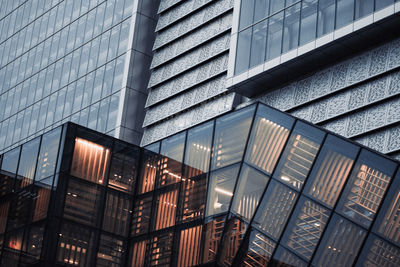 Low angle view of modern glass building in city