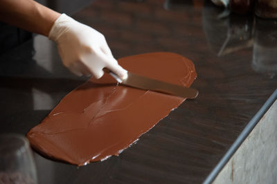 Midsection of person working on cutting board