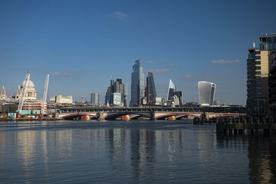 View of bridge over river with buildings in background