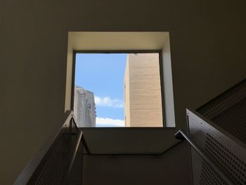 Low angle view of building from the bottom of a stairwell. 