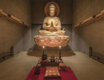 Buddha statue in illuminated building