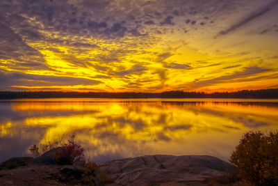 Scenic view of lake against romantic sky at sunset