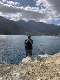 Man standing on mountain against sky