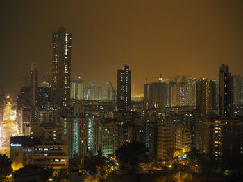 Illuminated cityscape against sky at night