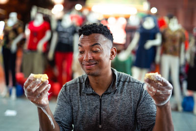 Close-up of a man holding ice cream outdoors