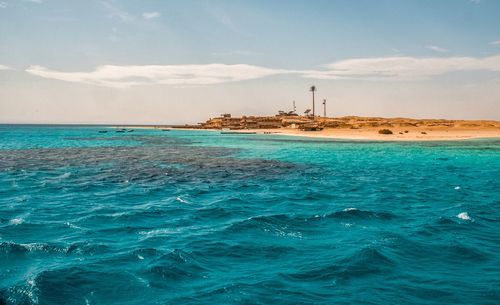 Scenic view of sea against cloudy sky