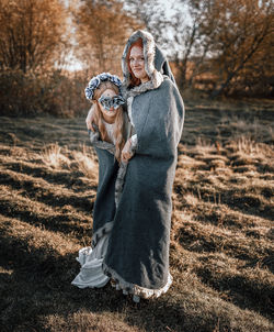 Portrait of a dog on woman during winter