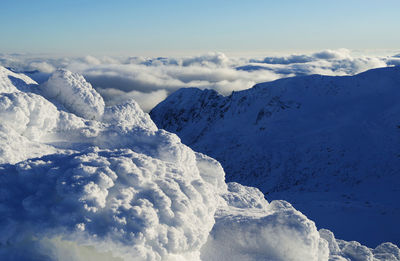 Scenic view of snow covered mountains against sky