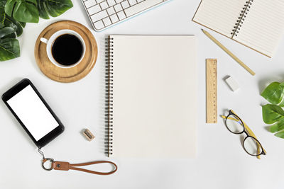 High angle view of eyeglasses and coffee cup on table