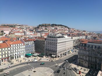 High angle view of road by buildings against clear sky