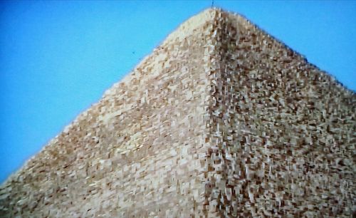 Low angle view of wall against blue sky