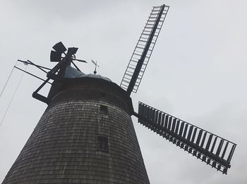 Low angle view of crane against sky