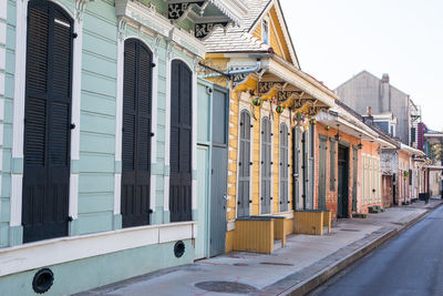 Street amidst buildings against clear sky in city