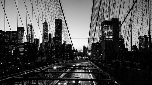 Low angle view of bridge and buildings against sky