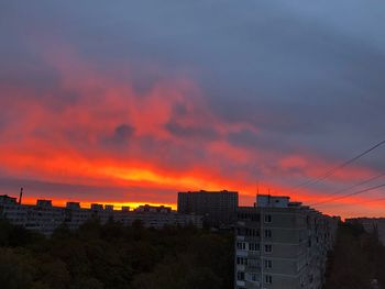 Exterior of buildings against orange sky