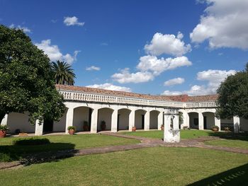 Lawn by building against sky